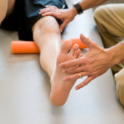 This is patient and physical therapist duing leg lifts.